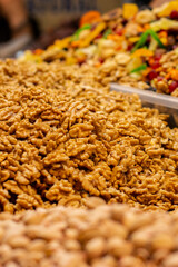 A seller selling delicious Afghan dry fruits walnuts snacks items at Industrial trade fair in Kolkata, West Bengal, India.