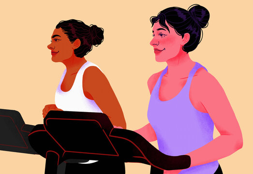 Smiling women exercising on treadmills in gym
