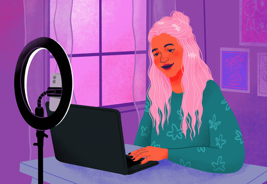 Teenage girl influencer filming at laptop behind ring light
