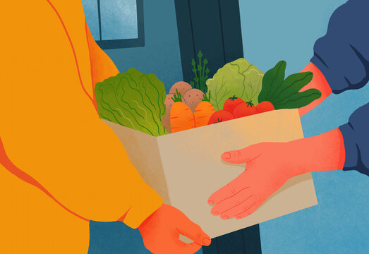 Hands of man delivering box of fresh vegetables at doorway
