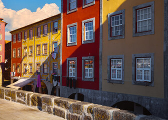 Porto, Portugal. Cosy street with traditional colorful houses. Windows and sun. Sunny summer day. Residential district beautiful antique buildings - obrazy, fototapety, plakaty