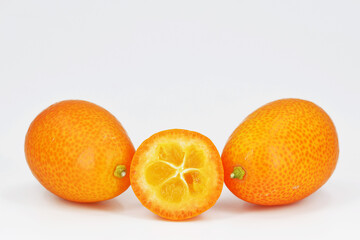 Fresh kumquat fruits, white background