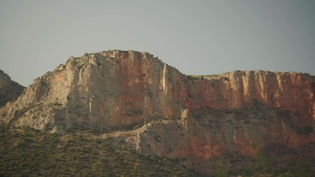 Stunning cliffs of Leonidio with epic exposed rocks and golden hour light casting across stone