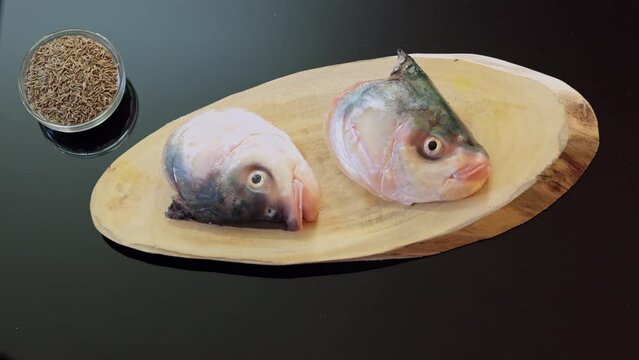Fish heads getting prepared to be cooked. Timelapse of a table top photography of head of fish