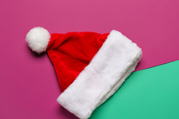 Christmas. red Christmas hat lies, color background, close-up. holiday celebration concept