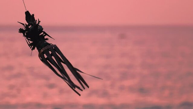 Silhouette of Traditional Decoration at Purple Sunset, Bali Indonesia