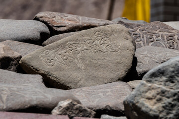 High angle close-up shot of Mani stones representing Buddhism concept.