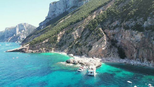 Ferry Boats at Cala Mariolu beach in Sardinia, Italy. Aerial