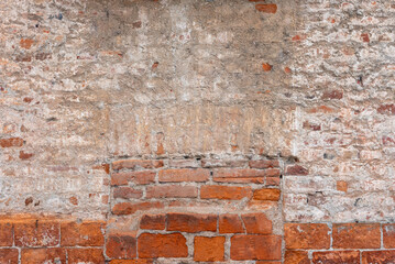 Old wall texture with plaster and peeling background with exposed brick. Background of wall with...