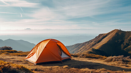 Orange tent on amazing meadow in spring mountains. Landscape photography, travel concept