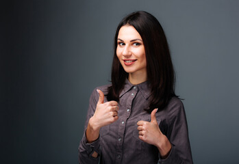 Witness the captivating moment as a confident woman triumphantly expresses her approval, optimism,...