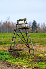 wooden hunting watch tower in late autumn fields