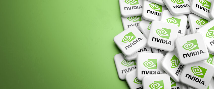 Logo of the tech company NVidia designing graphics card and server chips on a heap on a table. Copy space. Web banner format