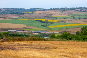 Fototapeta na wymiar Trakya Region train line and a train passing through sunflower fields