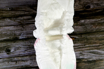 A diaper or a nappy, a type of underwear that allows the wearer to urinate or defecate without...