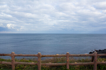 Fototapeta premium Wooden fence and Jeju seascape.