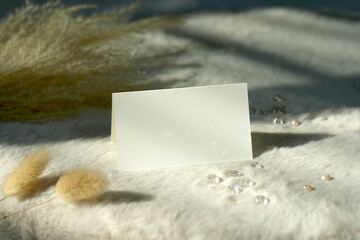 Mockup white blank space card, for Name place, Folded, greeting, invitation. on earthy neutral colors cloth background. with clipping path