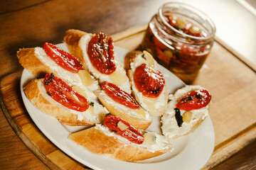 sandwiches with sun-dried tomatoes and cheese on a plate on the table