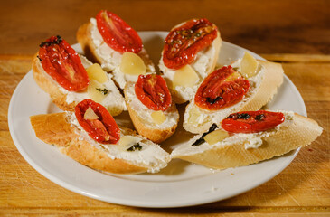 sandwiches with sun-dried tomatoes and cheese on a plate on the table