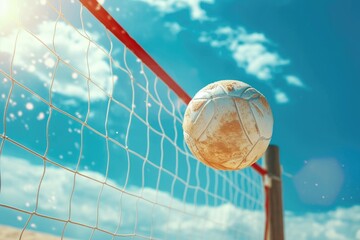 Volleyball ball sitting on top of a net. Suitable for sports-related designs and promotional materials