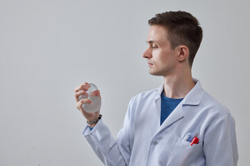 silicone breast implant in the hand of a plastic surgeon doctor, mastopexy concept, BREAST LIFT