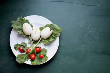 Fun, colorful creative boiled egg tulip flowers for children with cherry tomatoes for Easter eggs and kale for leaves to encourage kids to eat healthy foods.