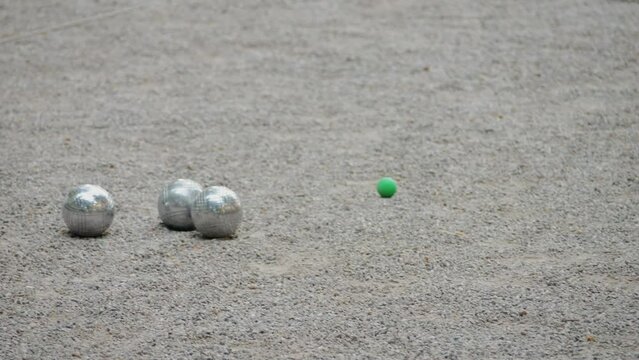 Petanque balls boules bowls on sand gravel court background in Barcelona, spain, traditional french game of petanque on the ground. 