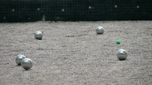 Petanque balls boules bowls on sand gravel court background in Barcelona, spain, traditional french game of petanque on the ground. 