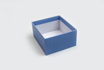 Open and empty blue decorative box for gifts on a white
