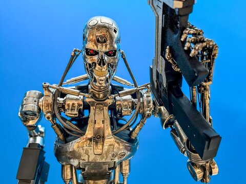 Madrid, Spain; 01-03-2024: Life-size figure of a T-800 from the movie Terminator, stripped of its human cover, leaving only its robotic skeleton while carrying a weapon in one of its hands.