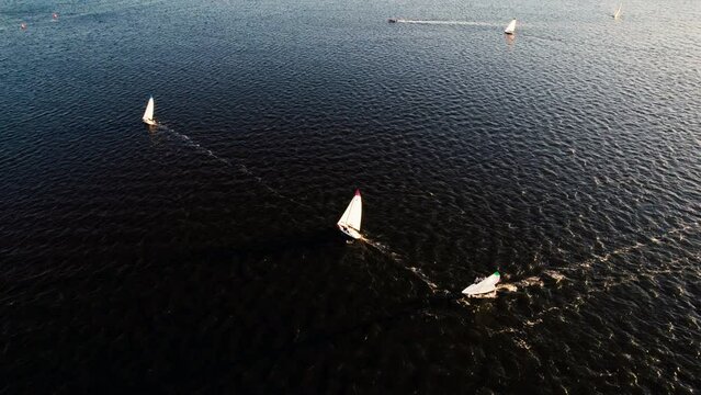 Top view of sailing yacht during the sunset. Sailing regatta. Flying over yachts in Swan river, Perth, Western Australia