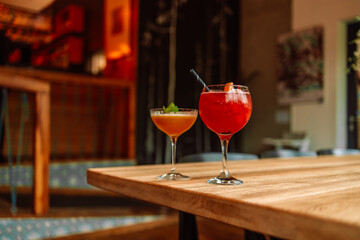 Cold summer cocktail mojito, margarita, daiquiri. Two glasses with fresh strawberry soda drink, ice...