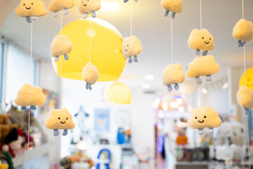 A cute cloud mobile with a smiley face hangs to decorate the interior of a cafe