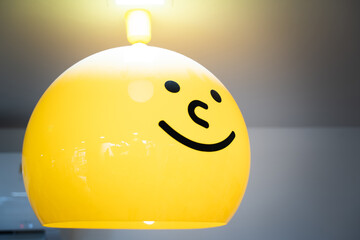 Yellow smiley face lamp on the cafe ceiling