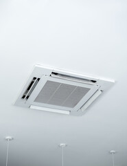 Ceiling mounted cassette type air conditioner decoration near ceiling lights on white building...