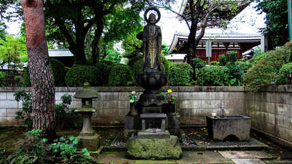 An ancient bronze statue of a deity near the Gokoku-ji temple in Tokyo. Japan