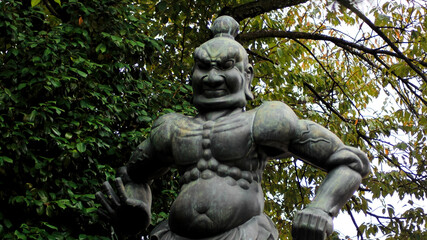 A statue of the Guardian God at the gate of the Gokoku-ji Buddhist Temple. Ikebukuro, Tokyo, Japan.