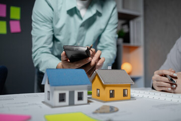 Commercial buildings are being evaluated by architects on what type of construction they need to be built, Engineers are designing a structure according to blueprints,