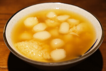 Glutinous rice balls in sweet rice wine. Close up traditional Chinese dessert. Served during Lantern Festival and Dongzhi Festival in China