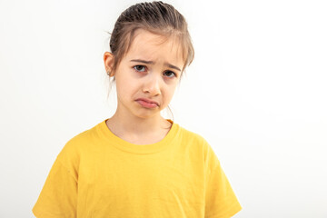 Sad Caucasian little girl on a white background isolated.