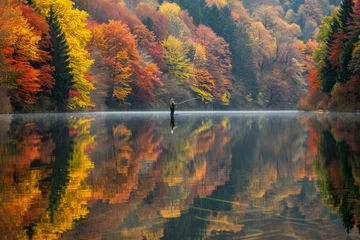 Foto auf Acrylglas A serene scene of a fisherman casting a line into a glassy lake, the reflection of colorful autumn trees mirrored on the water's surface --ar 3:2 --v 6 Job ID: 1cc55252-c65c-466f-8889-07c971577e33 © Artem