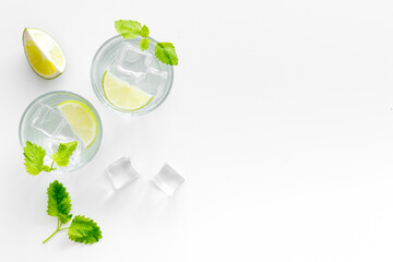 Refreshing cocktail mojito with mint and ice cubes in glasses, top view