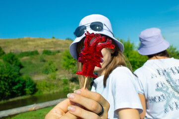 close-up - red lollipop in front of the girl's face