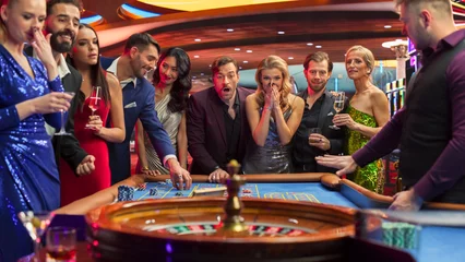 Foto op Plexiglas Las Vegas Casino Players Making Bets at a Roulette Table. Vibrant Crowd of International Young People Enjoying Nightlife in a City. Gamblers Excited About Successful Bets and Winning a Big Sum of Money