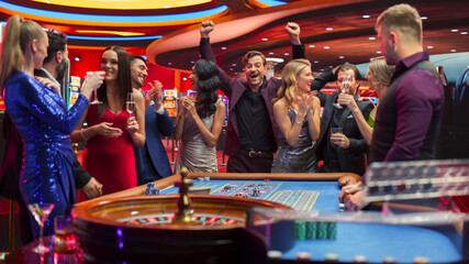Cinematic Footage of People Taking Risks and Placing Bets on a Roulette Wheel in a Casino. Croupier...