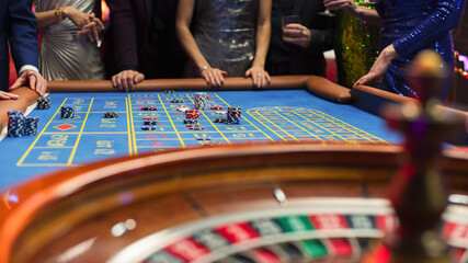 Successful Men and Women Partying in a Luxurious Casino. Young Anonymous People Gambling at a...