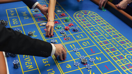 Anonymous Group of Rich Men and Women Gathered Around a Roulette Table at a Modern Casino....