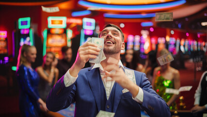 Happy Man in a Suit Standing in the Middle of a Modern Casino, Extending Arms, Welcoming a Money...