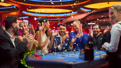 Group of Happy Diverse People Playing a Game of Blackjack in a Stylish Casino. People Celebrate the...