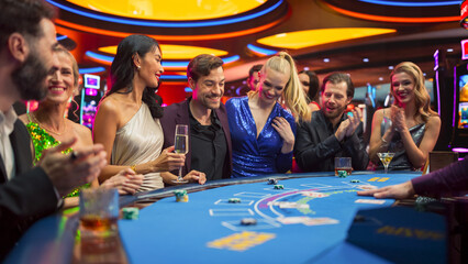 Portrait of People Cheering and Celebrating the Winner of a Blackjack Game in a Modern Casino. Group of Diverse Friends Having Fun on a Night Out Together, Living the Thrill of Gambling  